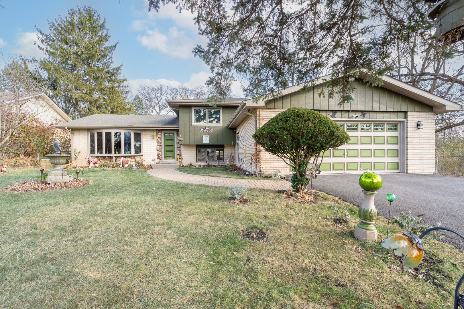 14061 High Road Lockport, IL 60441 - Photo 1 of 63 a front view of a house with a garden and trees