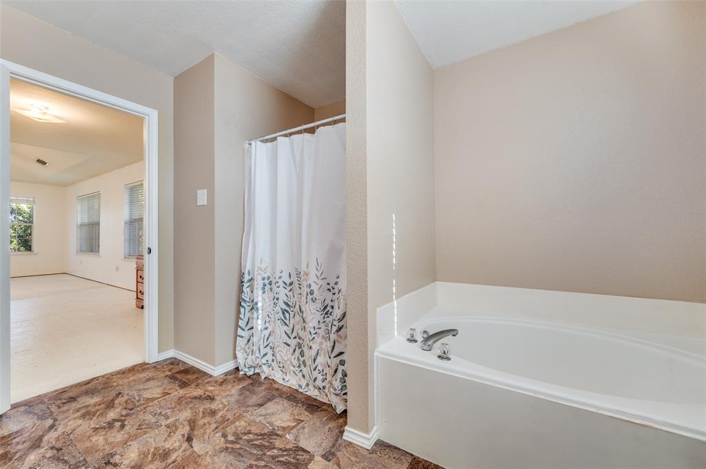 2516 Quail Ridge Road Melissa, TX 75454 - Photo 22 of 30 a bathroom with a bathtub and shower