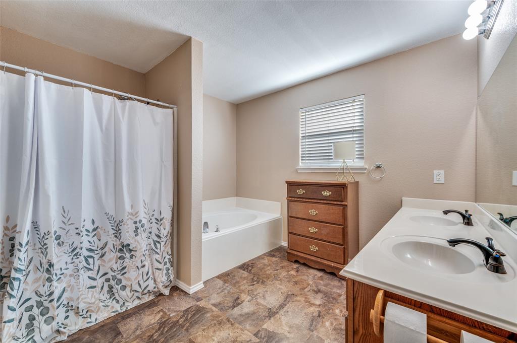2516 Quail Ridge Road Melissa, TX 75454 - Photo 24 of 30 a bathroom with a sink a vanity and a tub