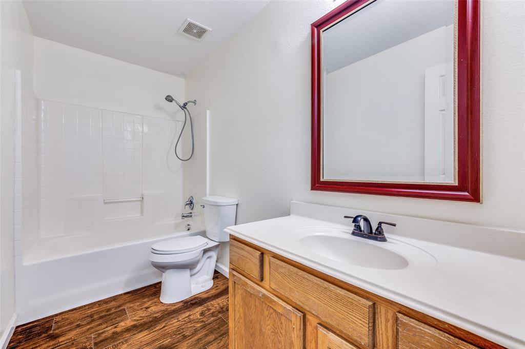 2516 Quail Ridge Road Melissa, TX 75454 - Photo 25 of 30 a bathroom with a sink toilet a mirror and shower