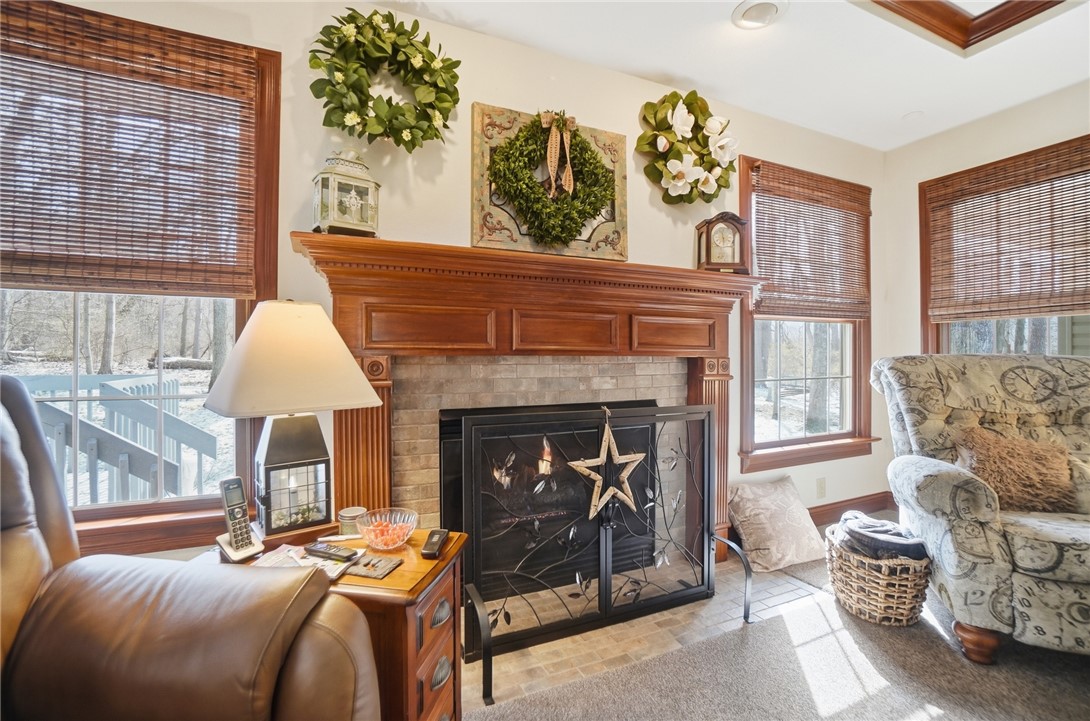 5300 Brookshire Lane Springfield, OH 45502 - Photo 10 of 56 This inviting living room features a classic fireplace with an elegant wood mantle and large windows.