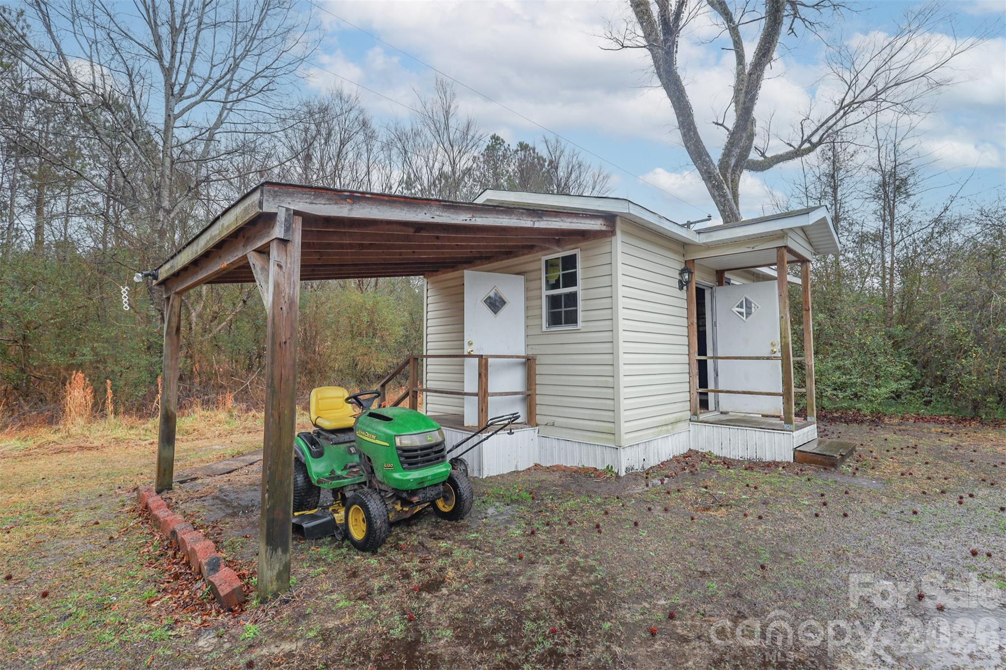1224 Astoria Road Jamesville, NC 27846 - Photo 30 of 34 a backyard of a house with table and chairs under an umbrella