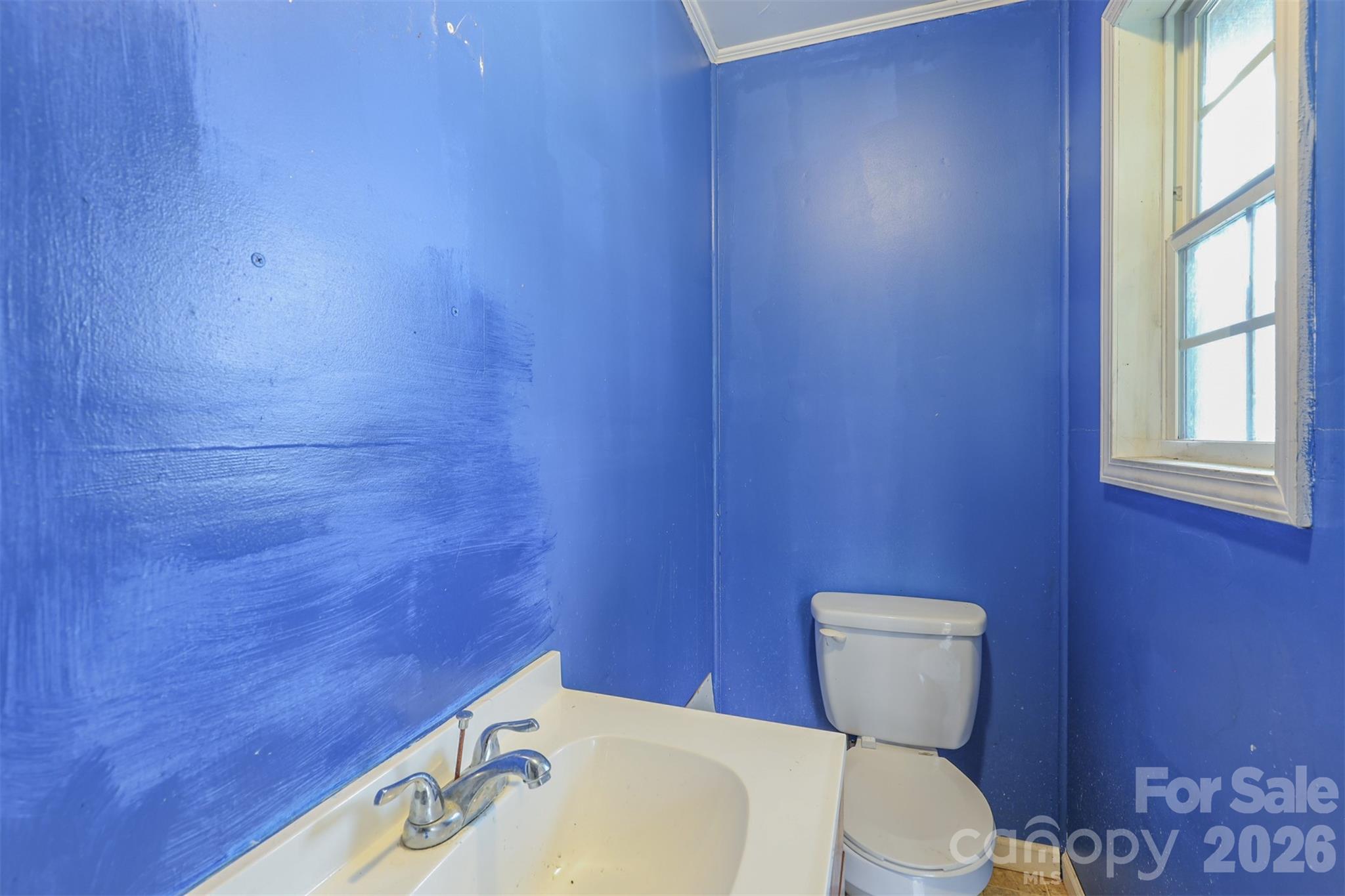 1224 Astoria Road Jamesville, NC 27846 - Photo 33 of 34 a white toilet sitting next to a white sink and vanity