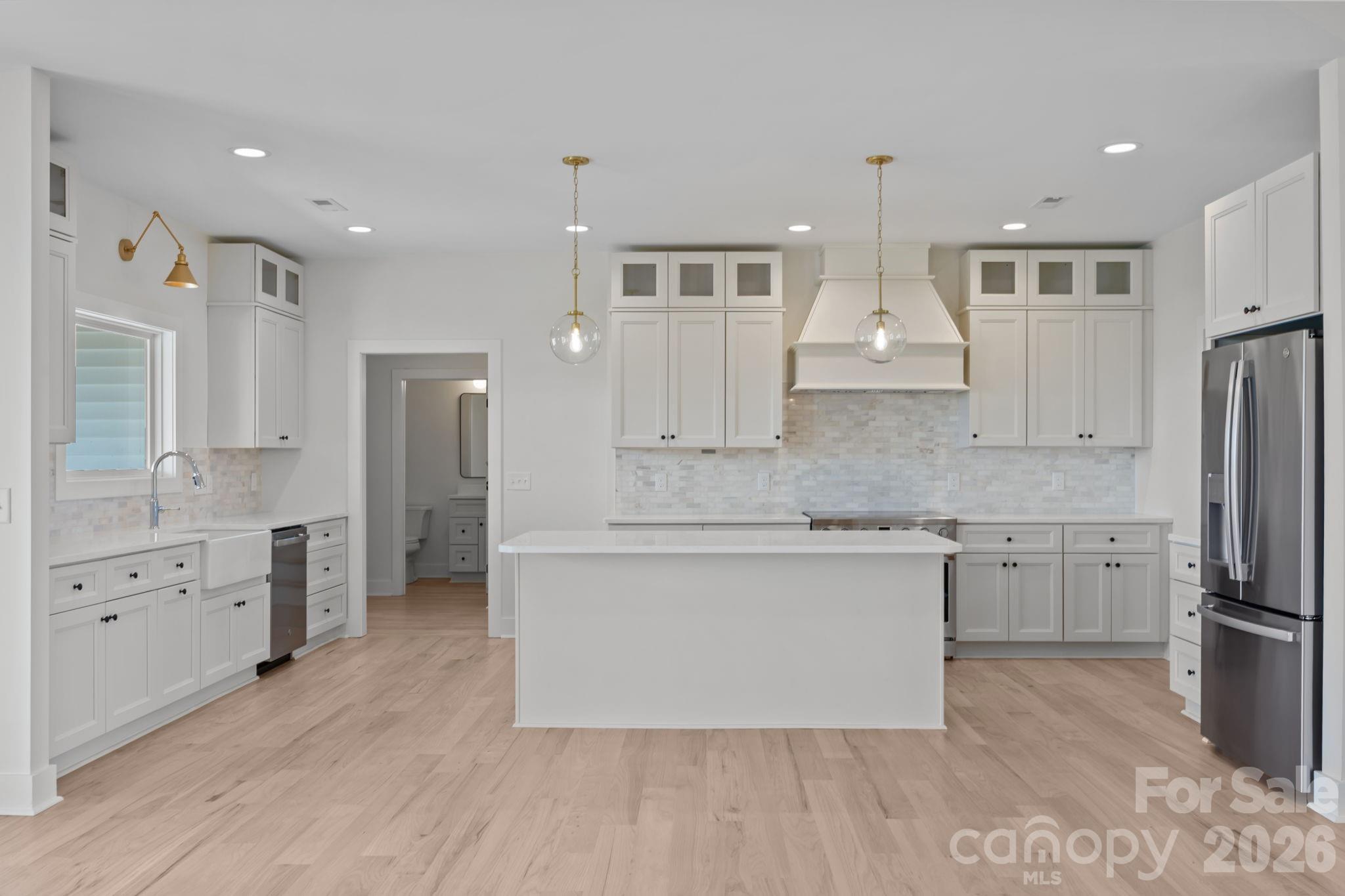 4805 Patterson Road China Grove, NC 28023 - Photo 16 of 42 a large kitchen with cabinets wooden floor and stainless steel appliances