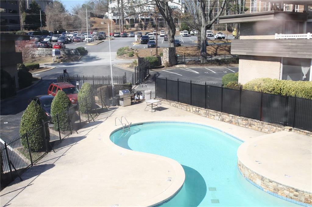 346 Carpenter Drive Northeast, Unit 7 Atlanta, GA 30328 - Photo 15 of 16 a swimming pool with outdoor seating and yard