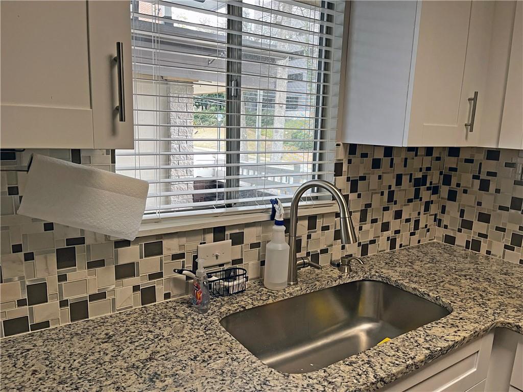 346 Carpenter Drive Northeast, Unit 7 Atlanta, GA 30328 - Photo 4 of 16 a kitchen with a sink and a white wooden cabinets