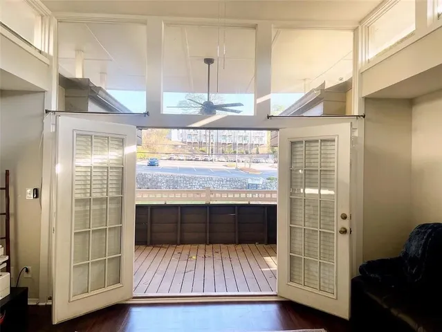 a room with wooden floor and windows