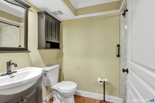 a bathroom with a sink mirror toilet and shower