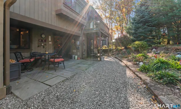 a backyard of a house with table and chairs