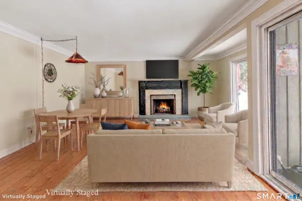 a living room with furniture a fireplace and a table