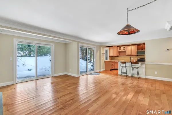 a view of a livingroom with furniture wooden floor and window