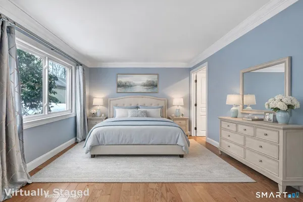 a bedroom with a large bed and a dresser