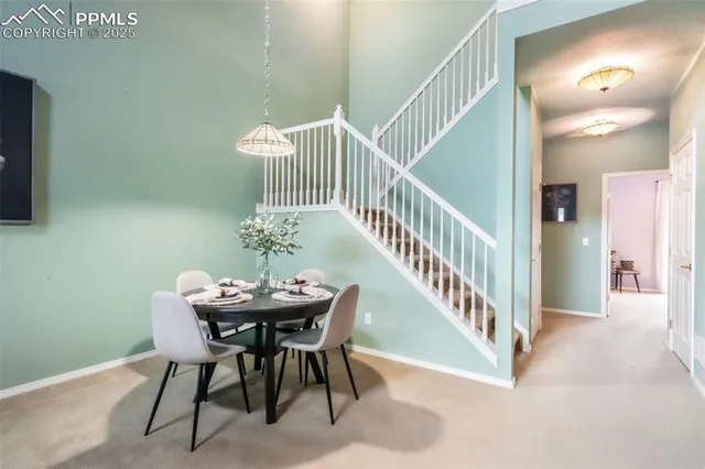 a dining room with furniture and wooden floor