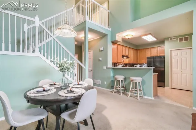 a view of a dining room with furniture and a chandelier