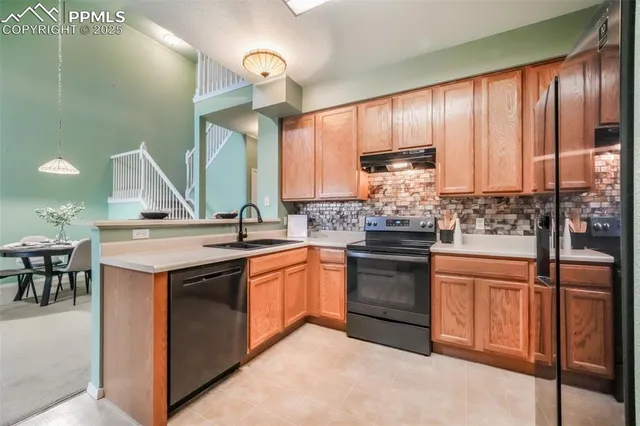 a kitchen with stainless steel appliances granite countertop a stove and a sink