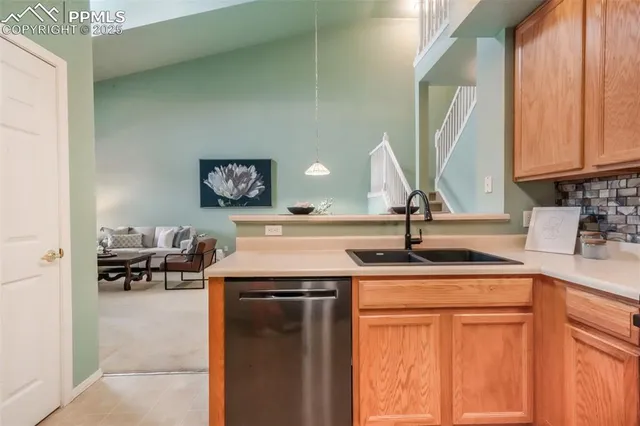 a view of a kitchen with a sink and a window