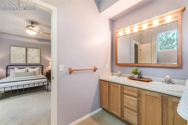 a en suite bathroom with a double vanity sink and a window