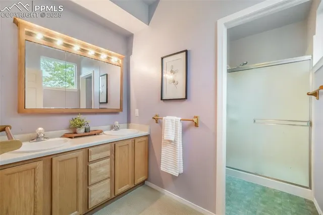 a bathroom with a double vanity sink mirror and