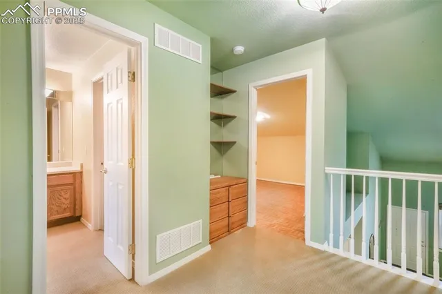 a view of a hallway with wooden floor and closet