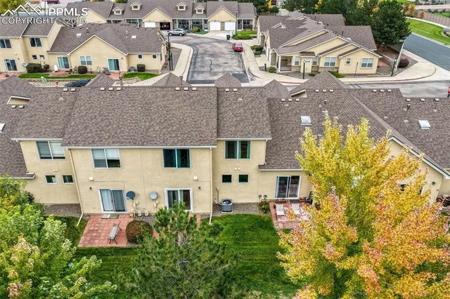 an aerial view of residential houses with yard