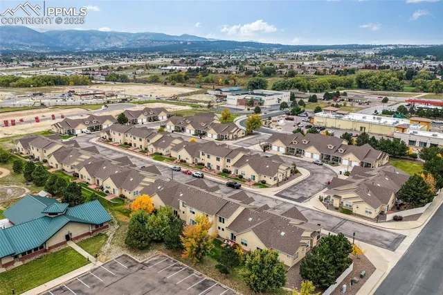 an aerial view of residential houses with outdoor space