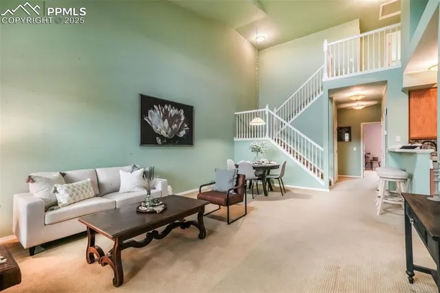 a living room with furniture and a painting