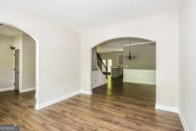 a view of empty room with wooden floor