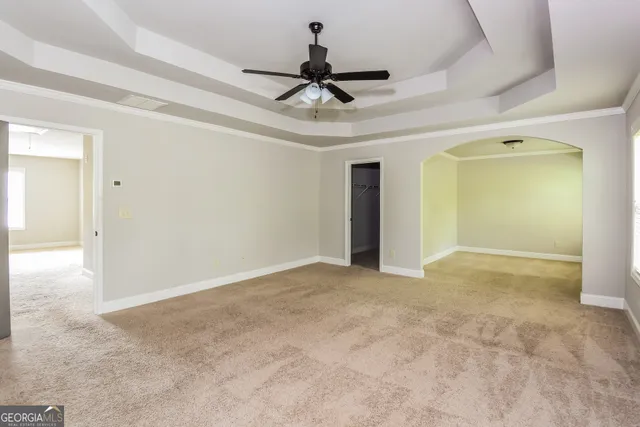 a view of empty room with ceiling fan