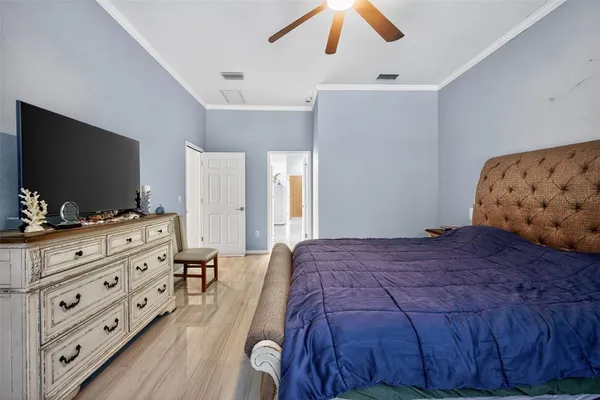 a bedroom with a bed and a flat screen tv in it