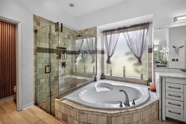 a bathroom with a tub and a shower