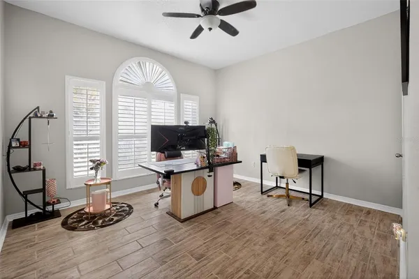 a view of a livingroom with workspace and a window