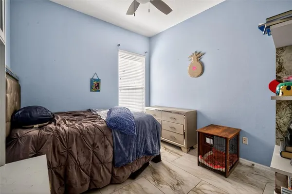 a bedroom with a bed and painting on the wall