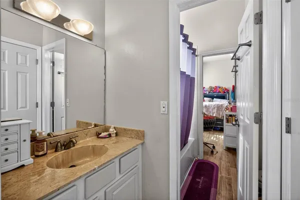 a bathroom with a sink vanity and a mirror