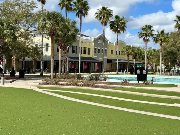 a front view of a building with palm trees