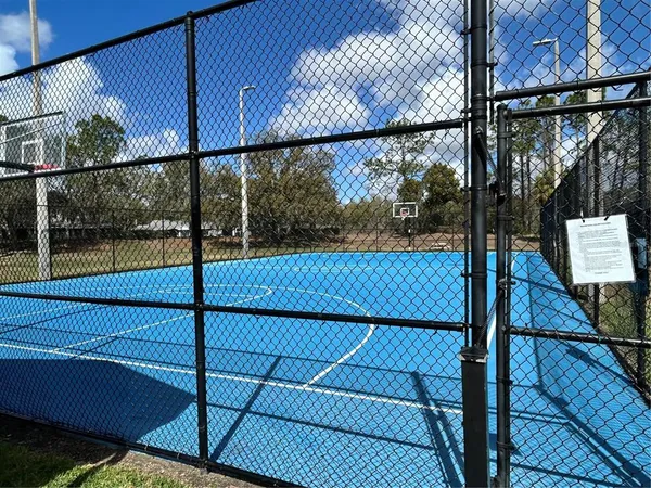 a view of a patio with a table and chairs under an umbrella