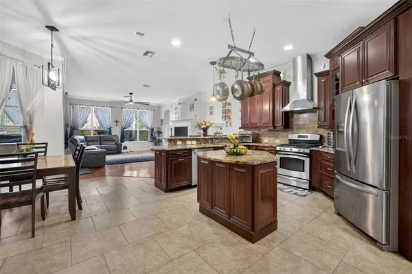 a kitchen with granite countertop stainless steel appliances and a refrigerator