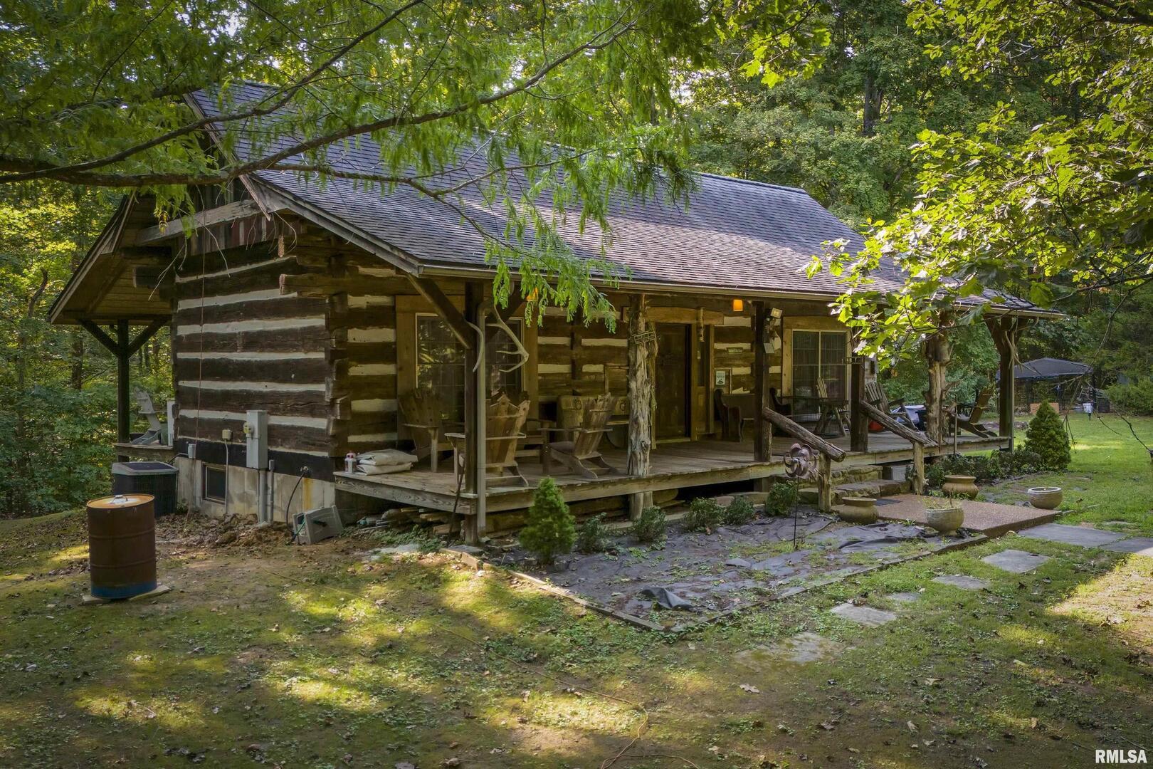 220 Timber Ridge Lane Jonesboro, IL 62952 - Photo 1 of 24 a view of a patio with a table and chairs under an umbrella