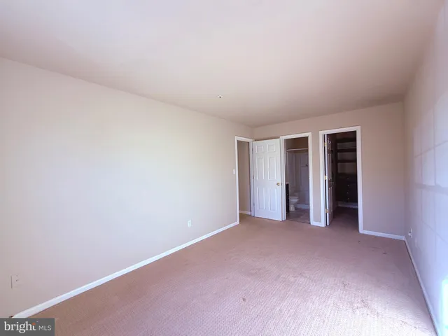 a view of an empty room with closet
