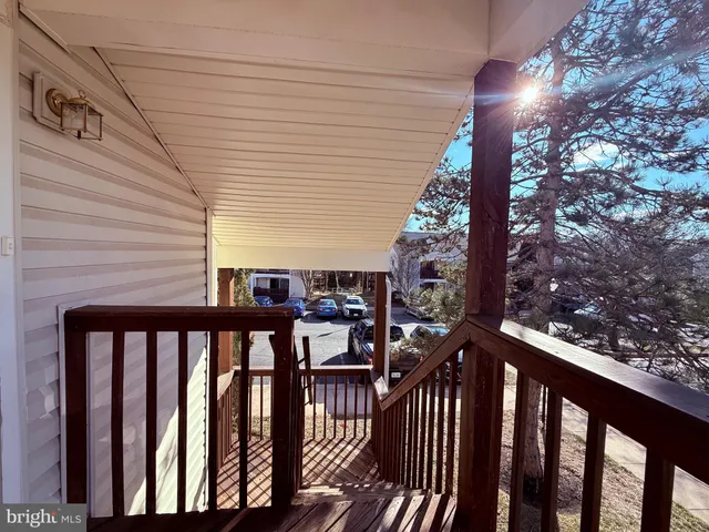 a view of a balcony with wooden floor