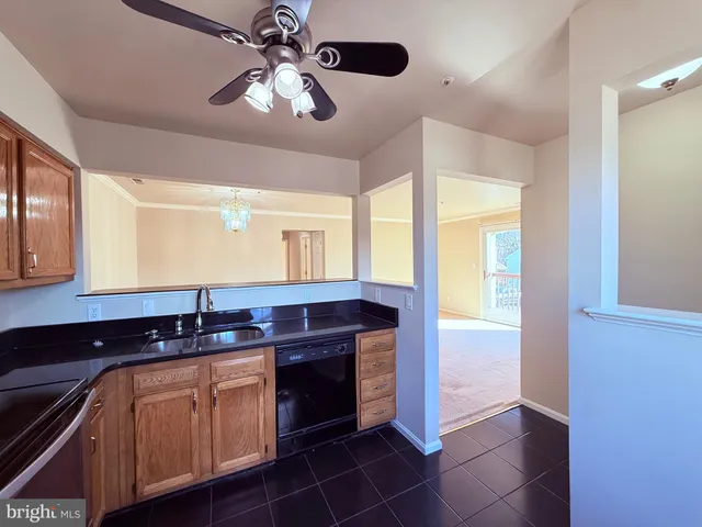 a kitchen with stainless steel appliances granite countertop a sink and cabinets