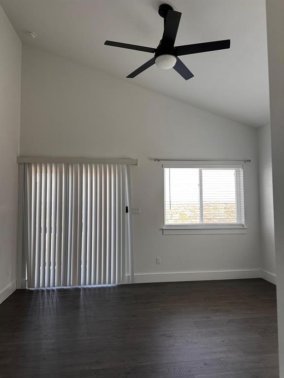 21210 Portsmouth Cove, Unit A Lago Vista, TX 78645 - Photo 7 of 10 an empty room with wooden floor fan and windows