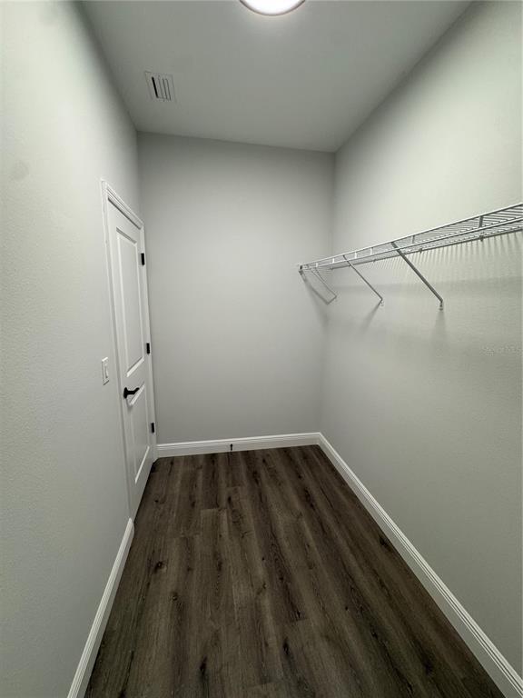 7105 Princeton Street Port Charlotte, FL 33981 - Photo 14 of 26 a view of a room with wooden floor and cabinets