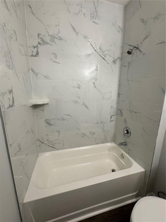 7105 Princeton Street Port Charlotte, FL 33981 - Photo 20 of 26 a bathroom with a bathtub and a toilet