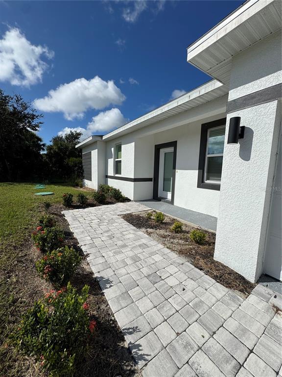 7105 Princeton Street Port Charlotte, FL 33981 - Photo 2 of 26 a view of a house with a yard