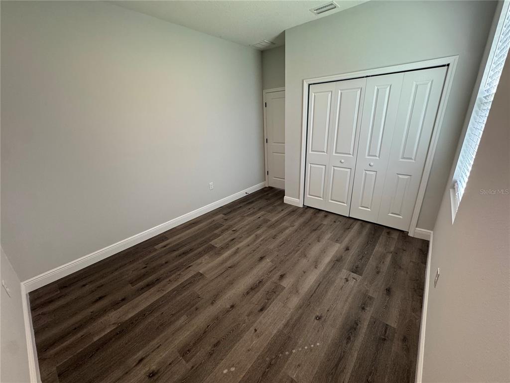 7105 Princeton Street Port Charlotte, FL 33981 - Photo 25 of 26 a view of an empty room with wooden floor