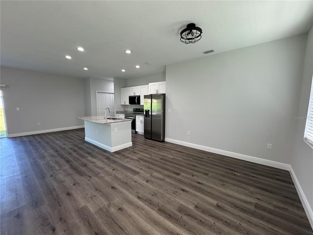 7105 Princeton Street Port Charlotte, FL 33981 - Photo 3 of 26 a view of a kitchen with wooden floor and an entryway