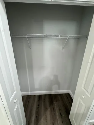 a view of closet with wooden floor