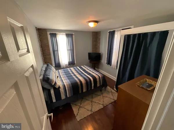 a bedroom with a bed and a mirror