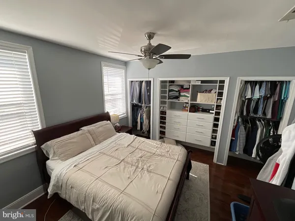 a bedroom with bed and wooden floor