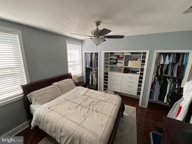 a bedroom with bed and wooden floor